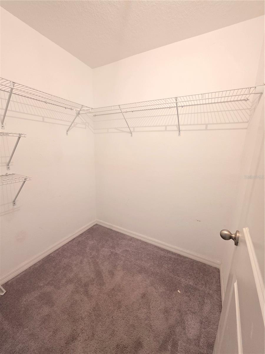 Walk in closet for primary bedroom.