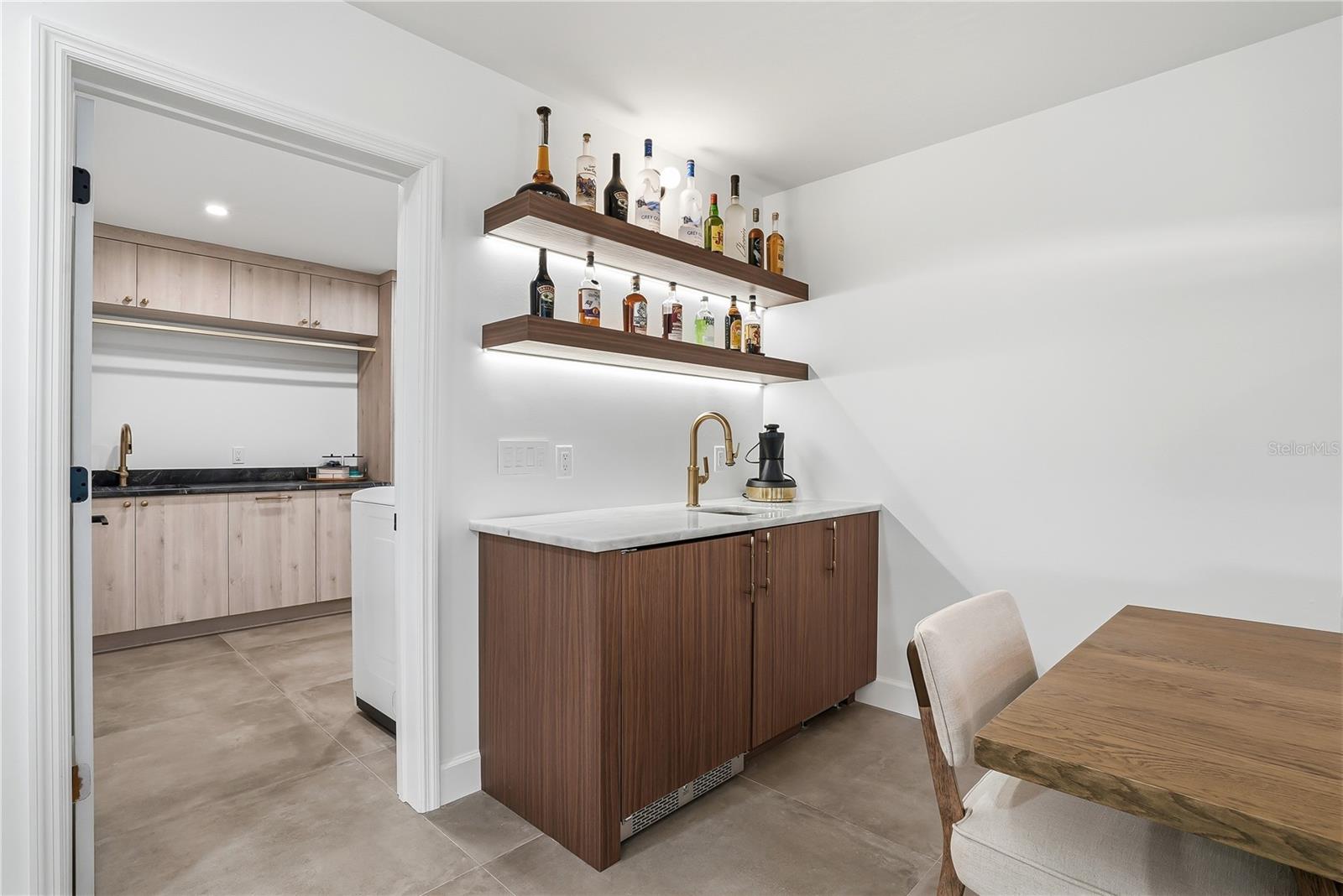 Wet Bar with Ice Machine and Laundry Beyond