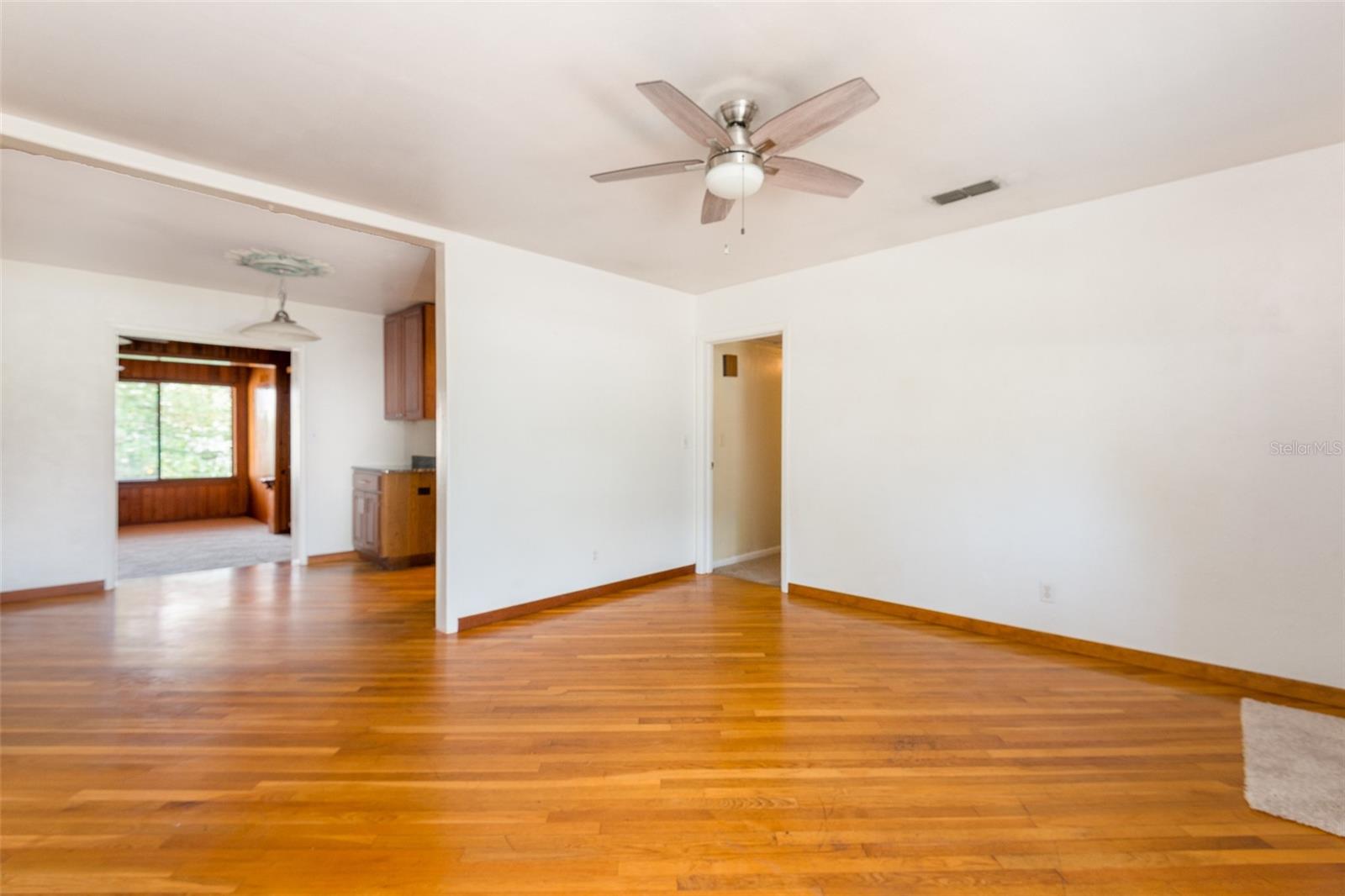 The living room flows into the dining room.