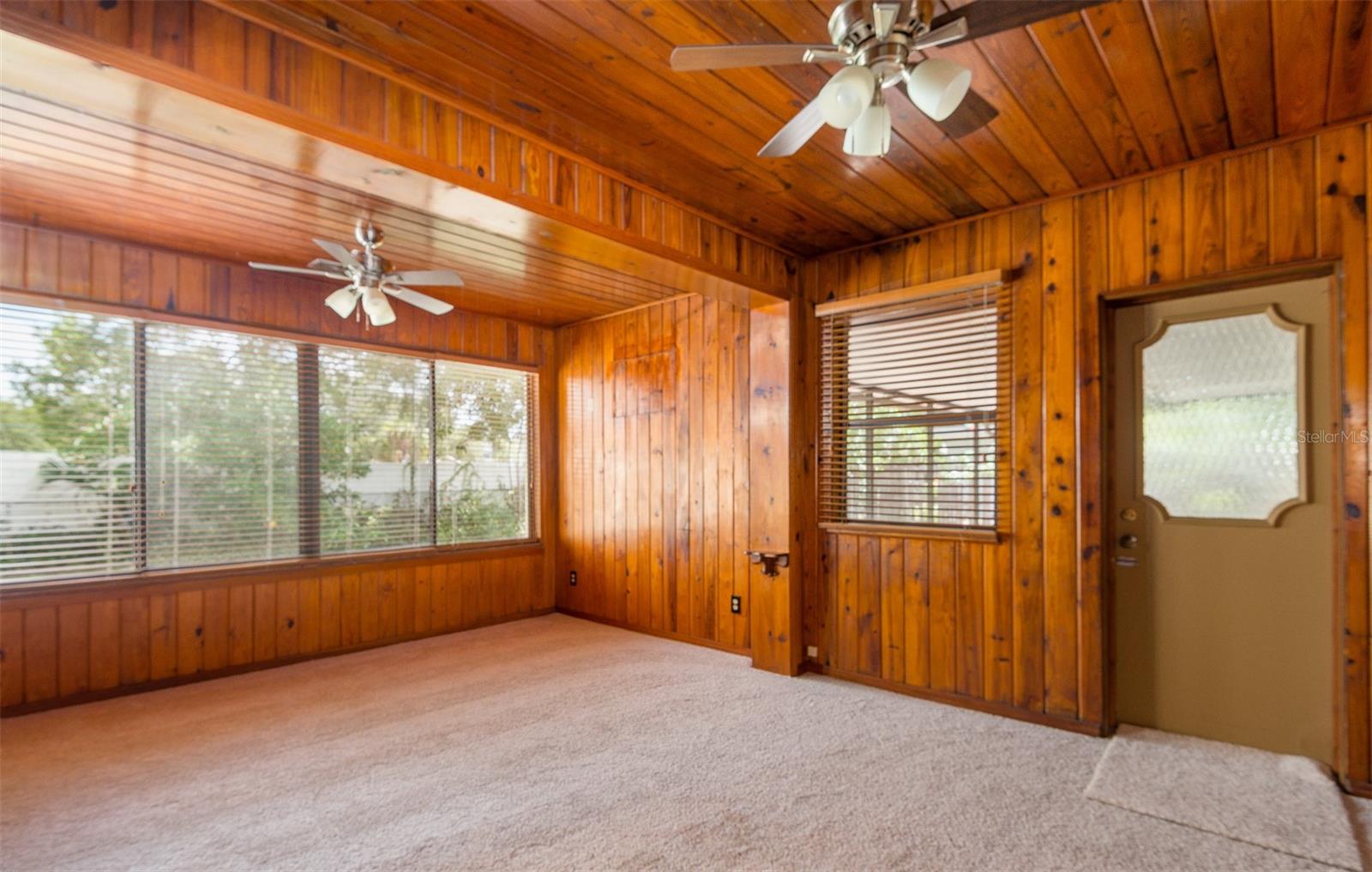 This space is warm and comfortable, overlooks the yard. Door leads out to the screened lanai.