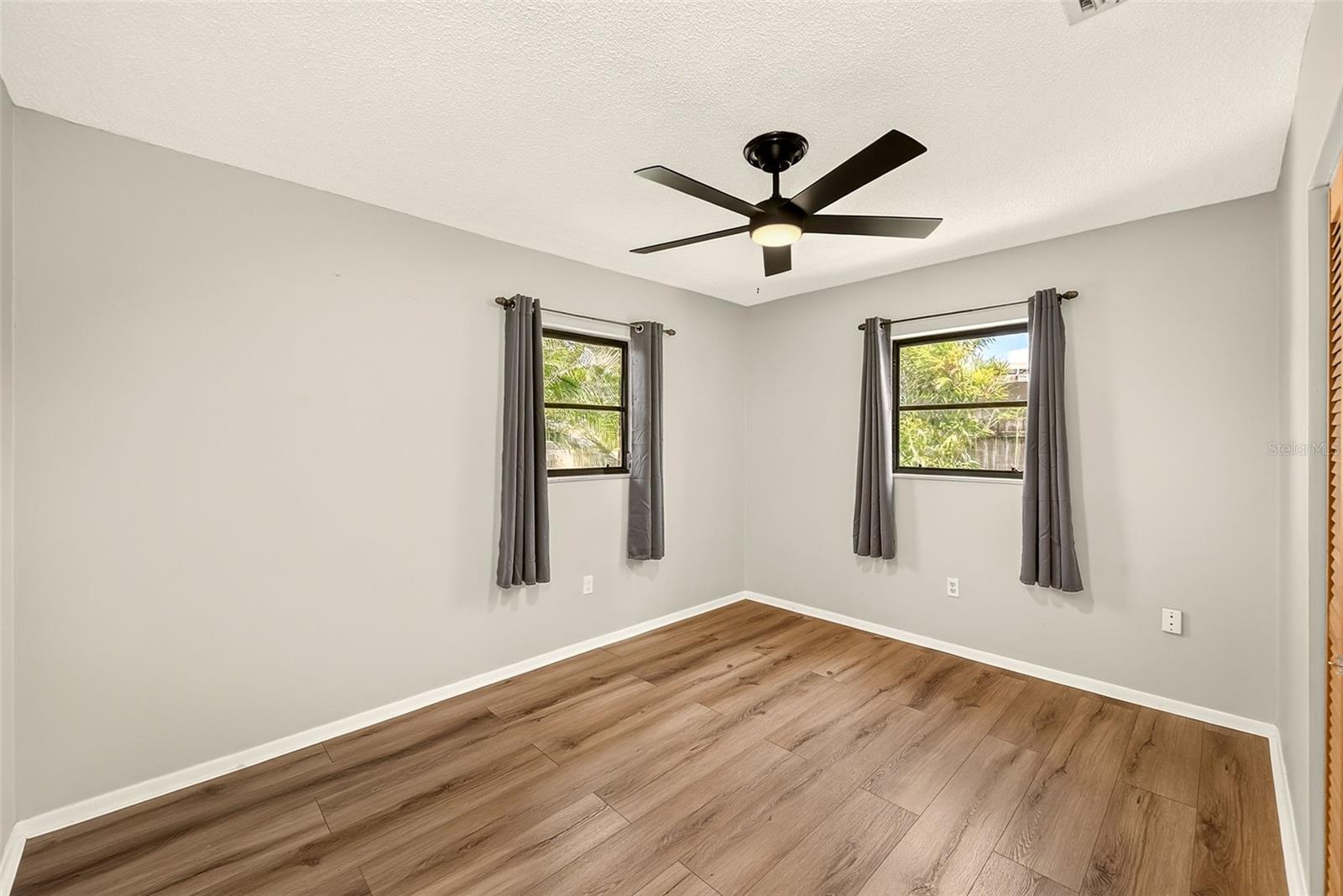 Bedroom 2 with newer luxury vinyl flooring