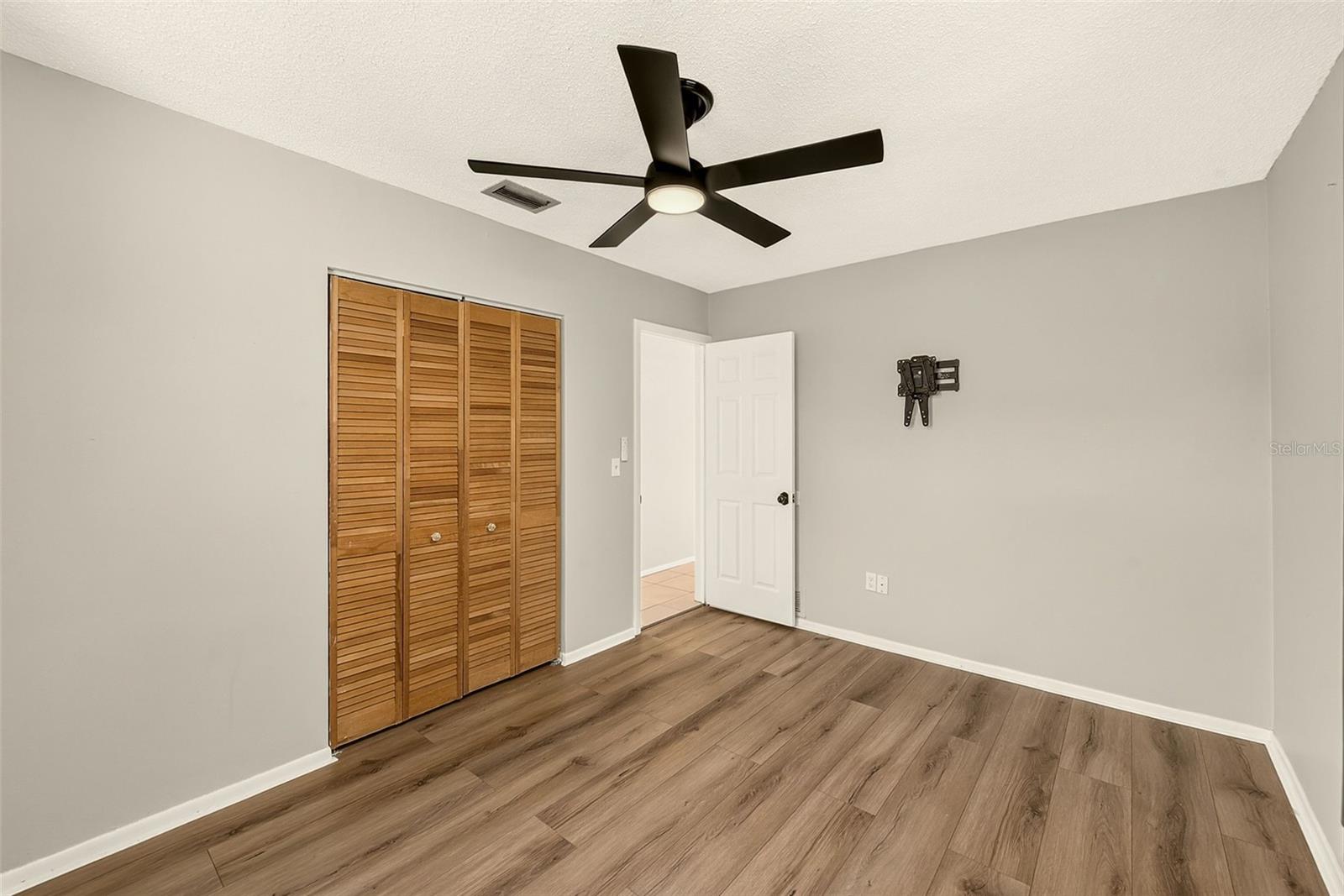 Bedroom 2 with newer ceiling fan and large closet