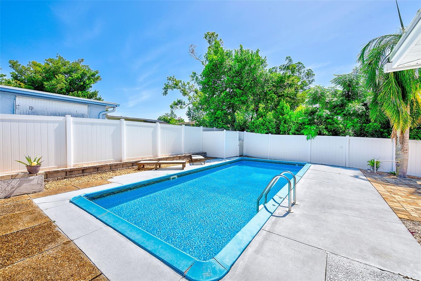 View of sparkling inground swimming pool