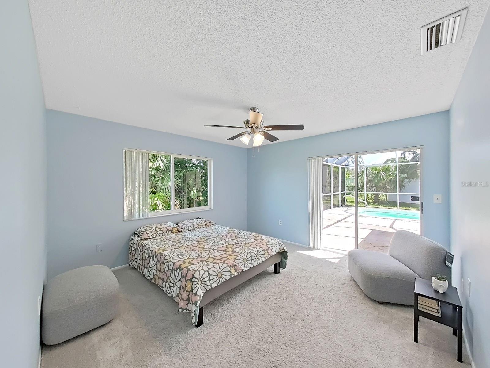 Primary Bedroom with slider leading to pool area