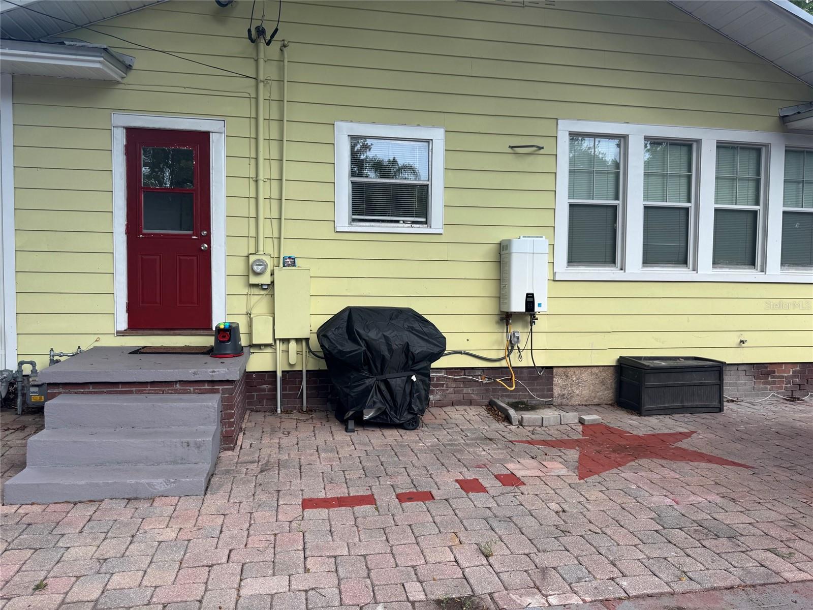 Side of home showing tankless HW Heater
