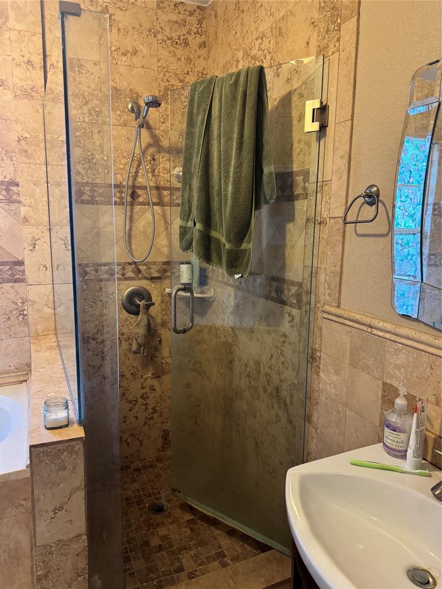 Tiled shower in primary bedroom