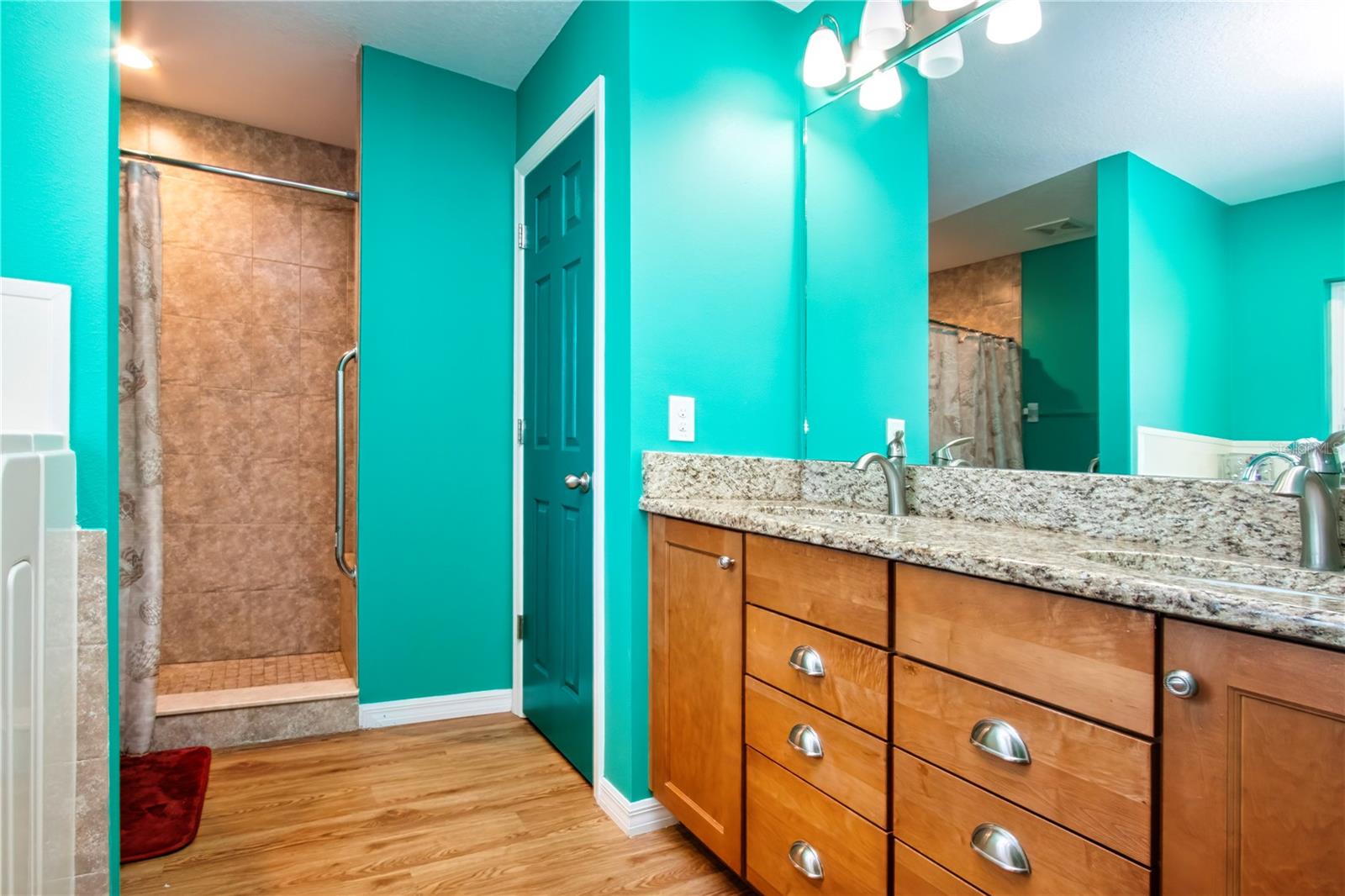 Stand alone shower with security bars, built-in bench seat and a linen closet
