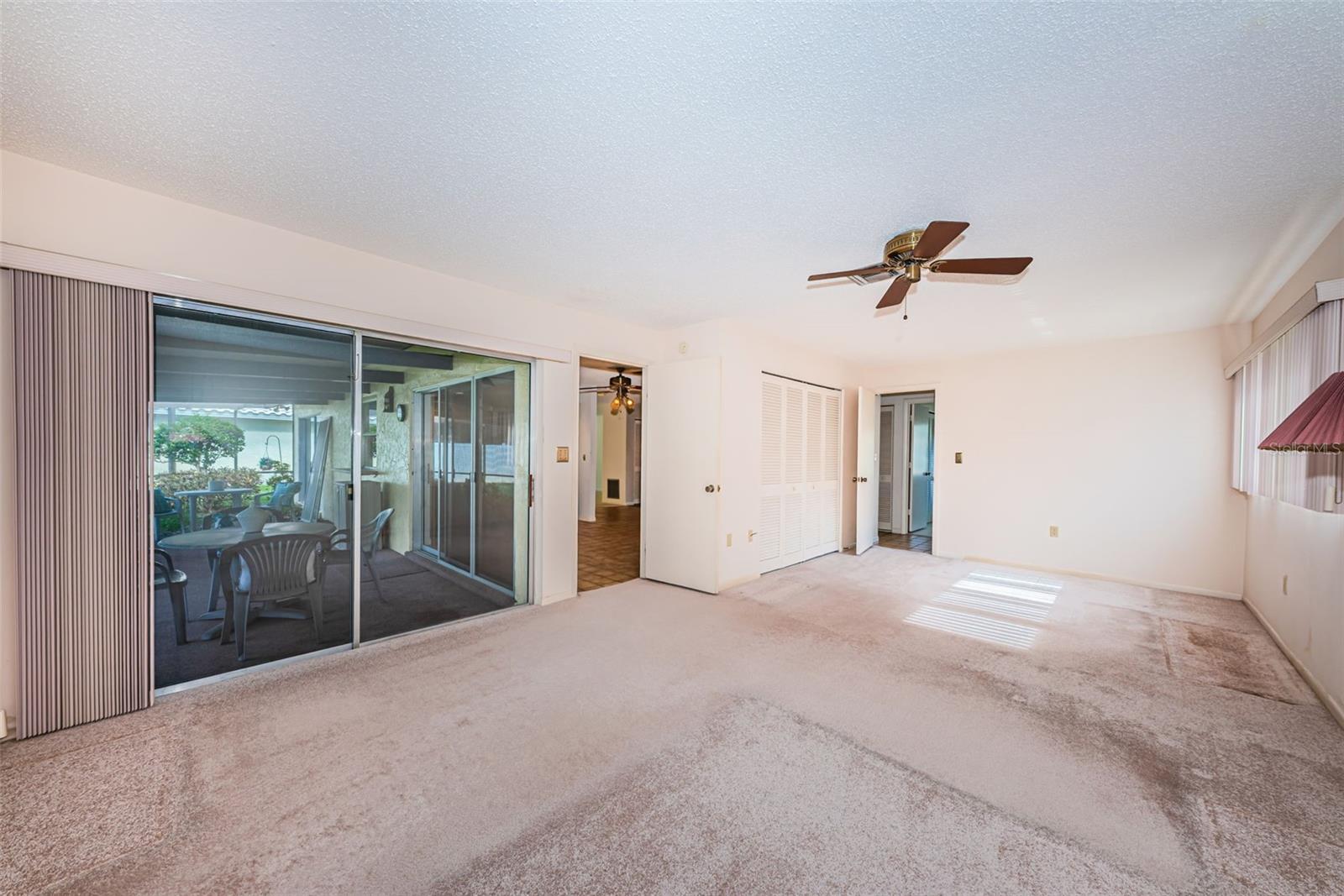 Primary suite with sliders onto the screened porch