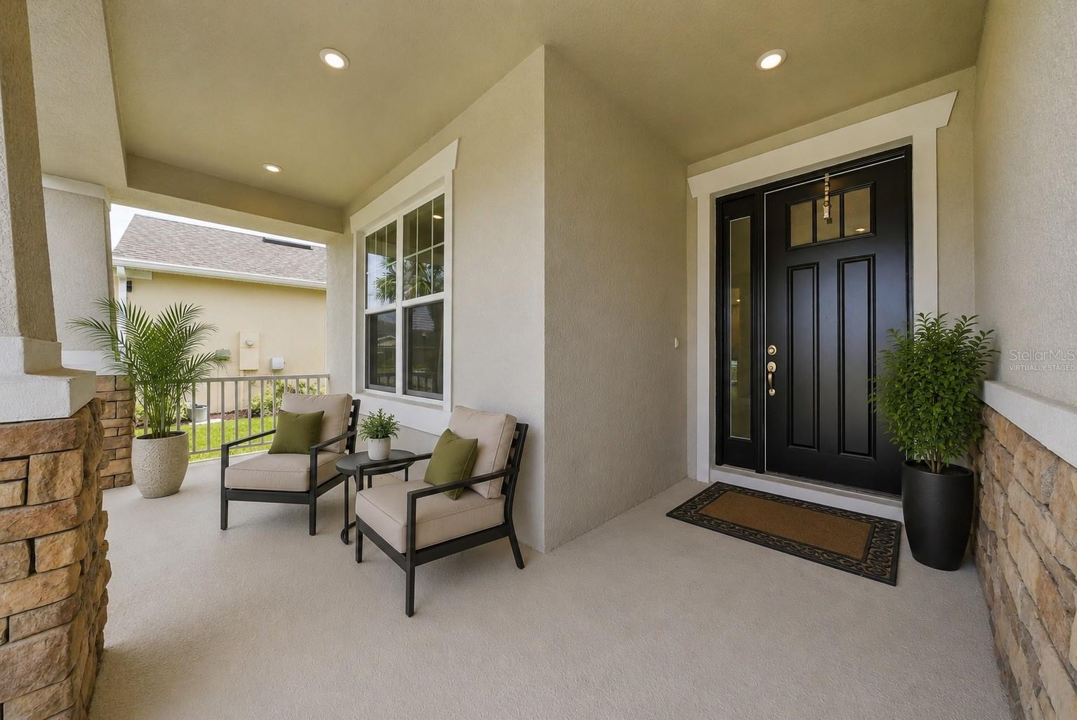 Nice covered porch to enjoy your morning or evening beverage! - Virtually Staged