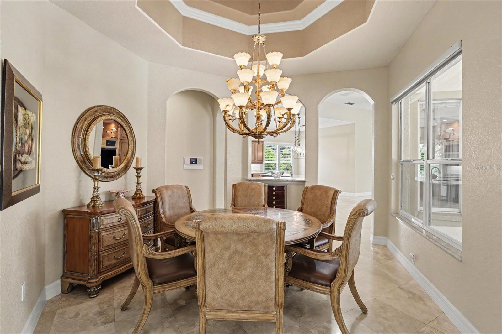 Elegant formal dining accented with tray ceiling and crown molding