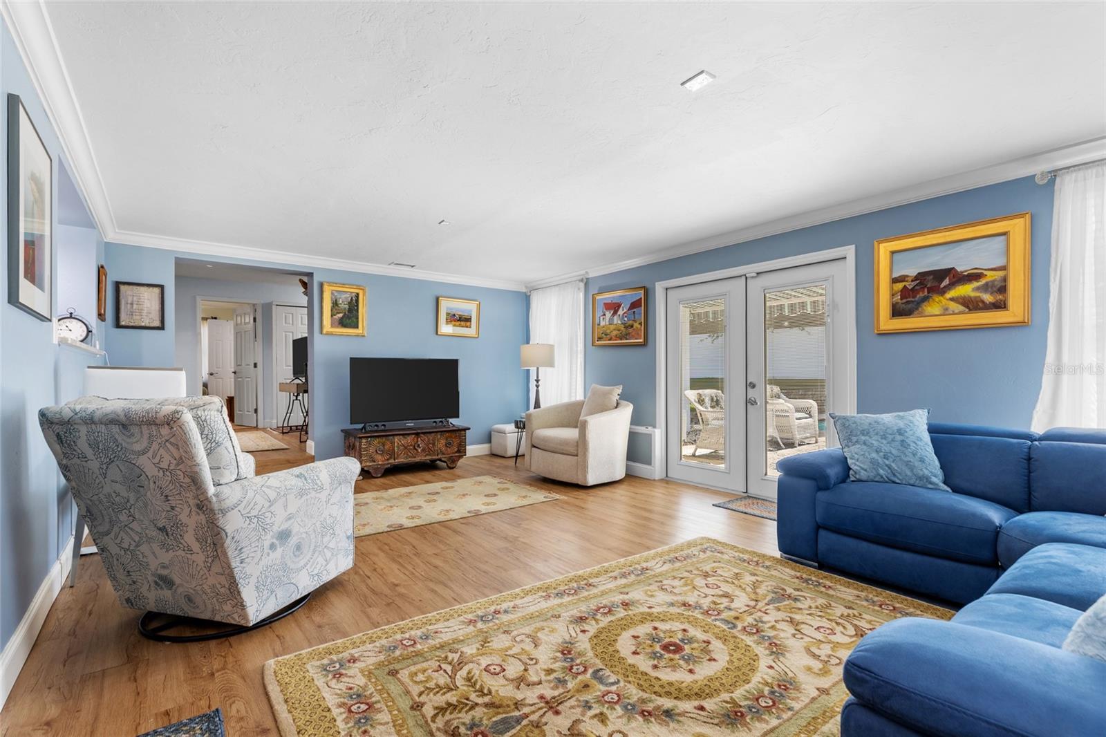 Great Room, with French doors opening to the backyard and  pool.