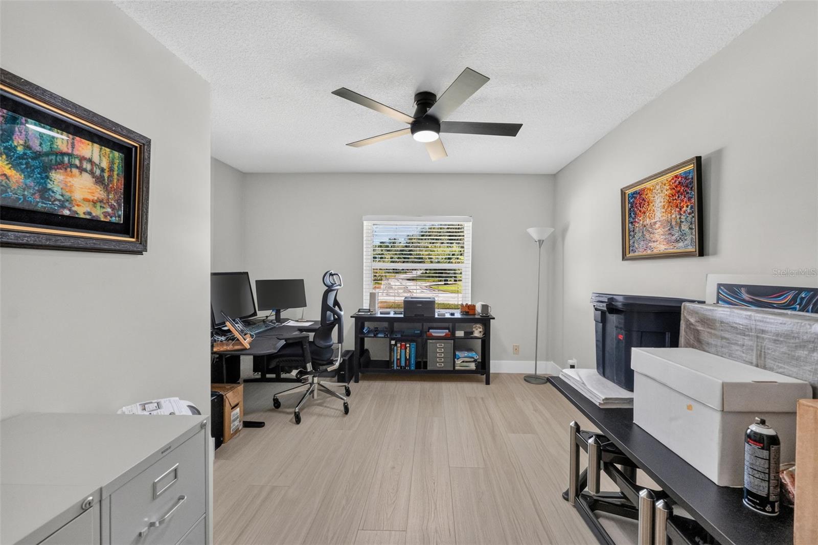 Bedroom 2 featuring luxury vinyl plank floors, offering a bright and inviting space for family, guests, or as an office.