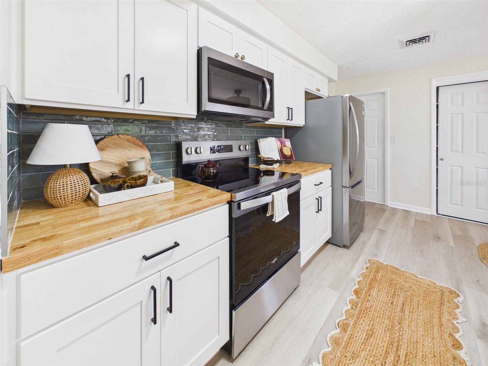 Beautifully remodeled kitchen with new soft-close cabinets, all new appliances, new butcher block counters.