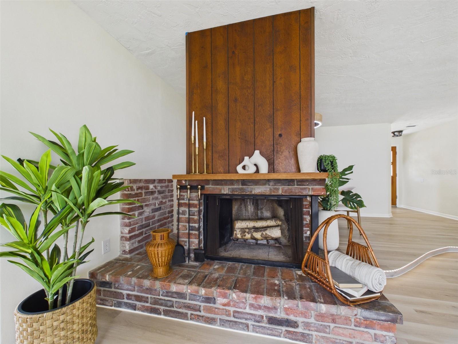 Double-sided wood burning fireplace with original brick and materials