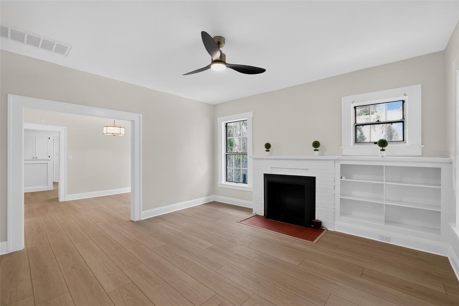 Spacious living room featuring original fireplace in this classic 1922 bungalow