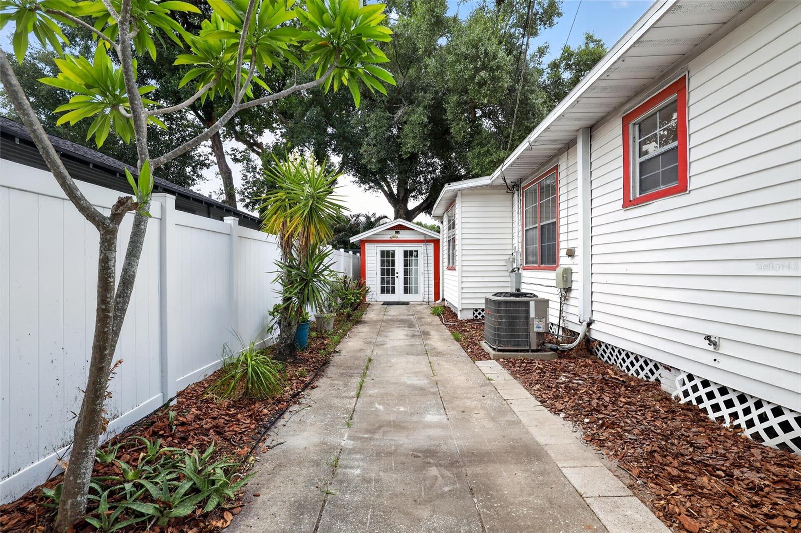Private side walkway leading to the detached garage in this 1922 bungalow