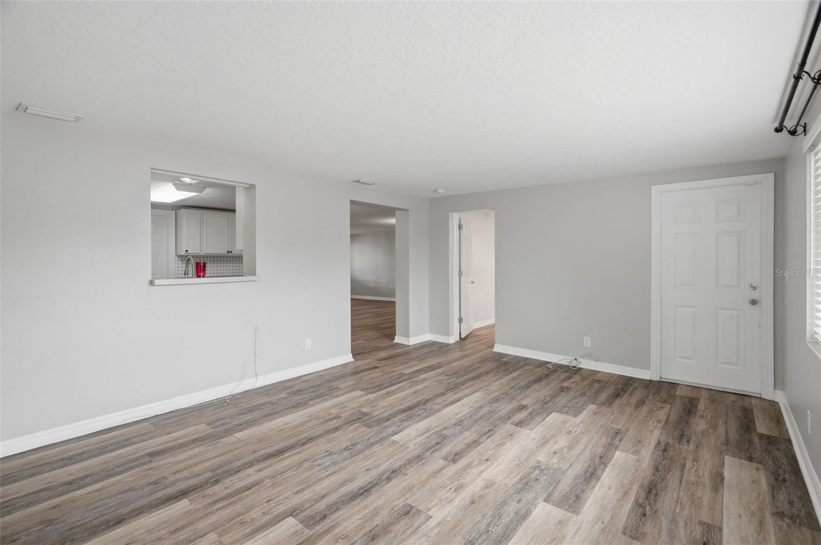 Family Room off of Kitchen. Door to left is to 3rd bedroom, door to right goes out to backyard