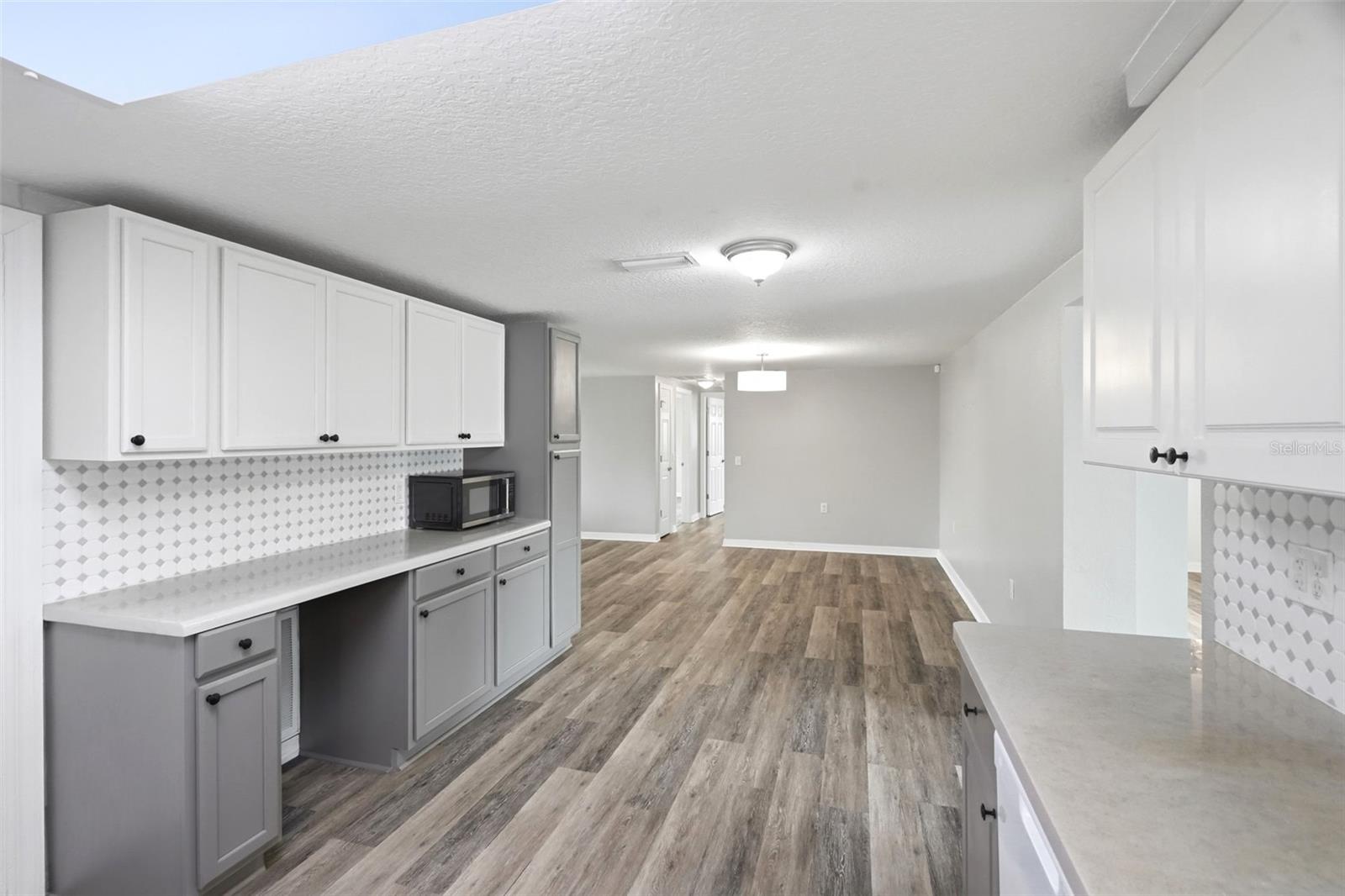 Walking back through the kitchen toward the Primary & Second Bedrooms