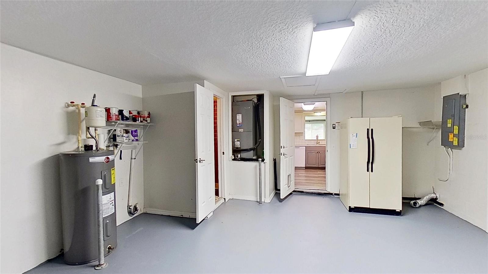 Oversized Garage, Second Fridge conveys. Half-Bath door to the left. Laundry hookups.