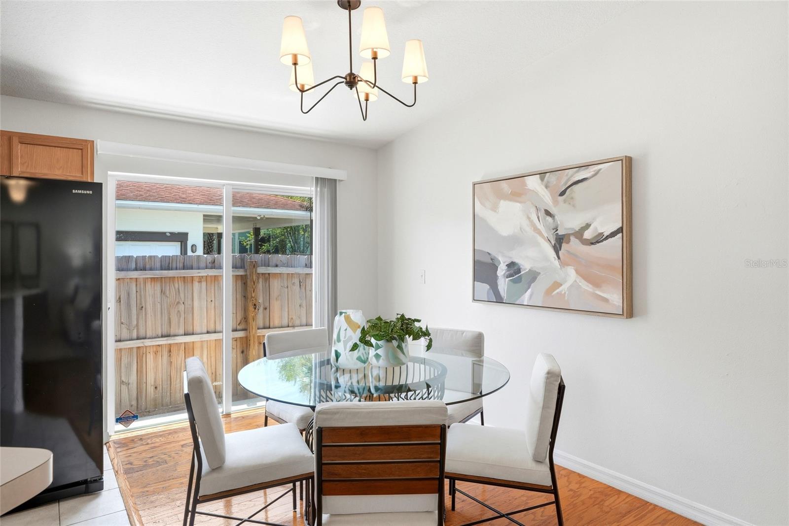 The dining area's sliding glass door leads straight out to the fully fenced backyard and patio.