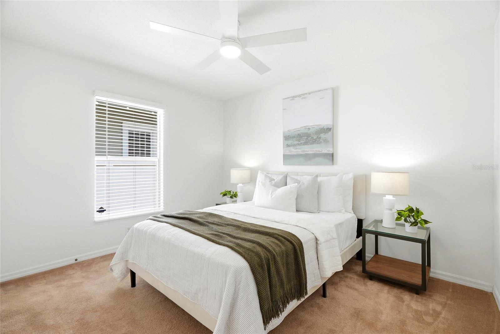 Ceiling fans and 1-inch wood blinds add timeless style and comfort to every bedroom.