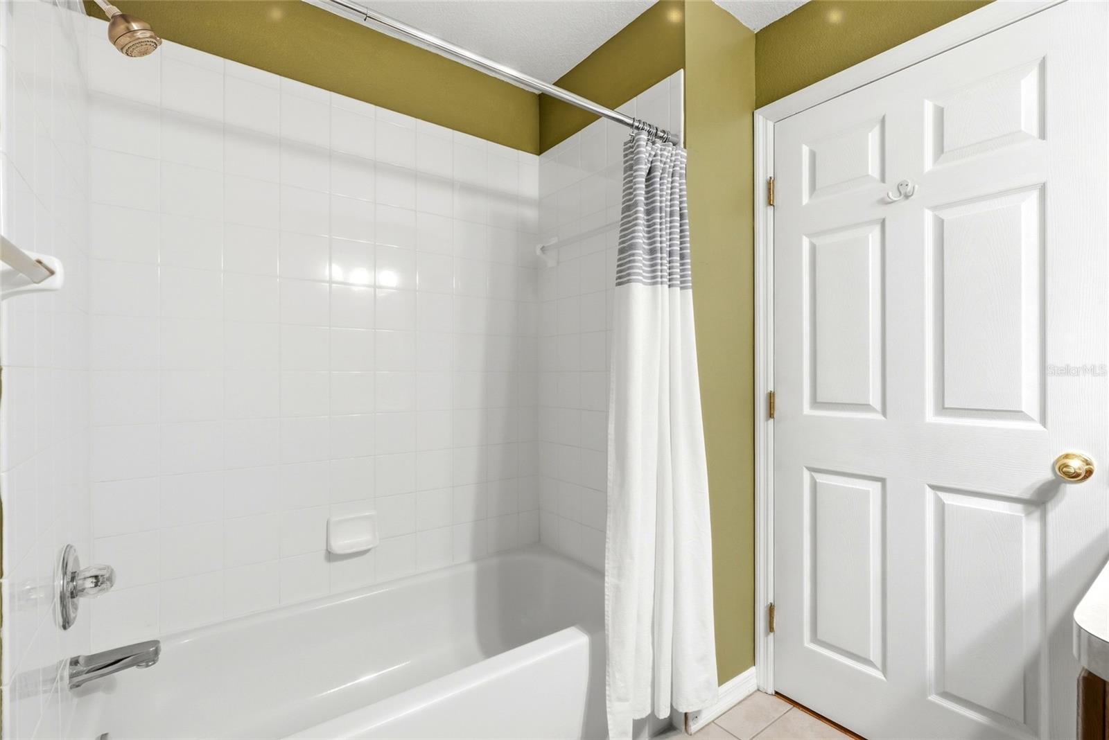 The guest bathroom features a shower/tub combo, ideal for family or guests.