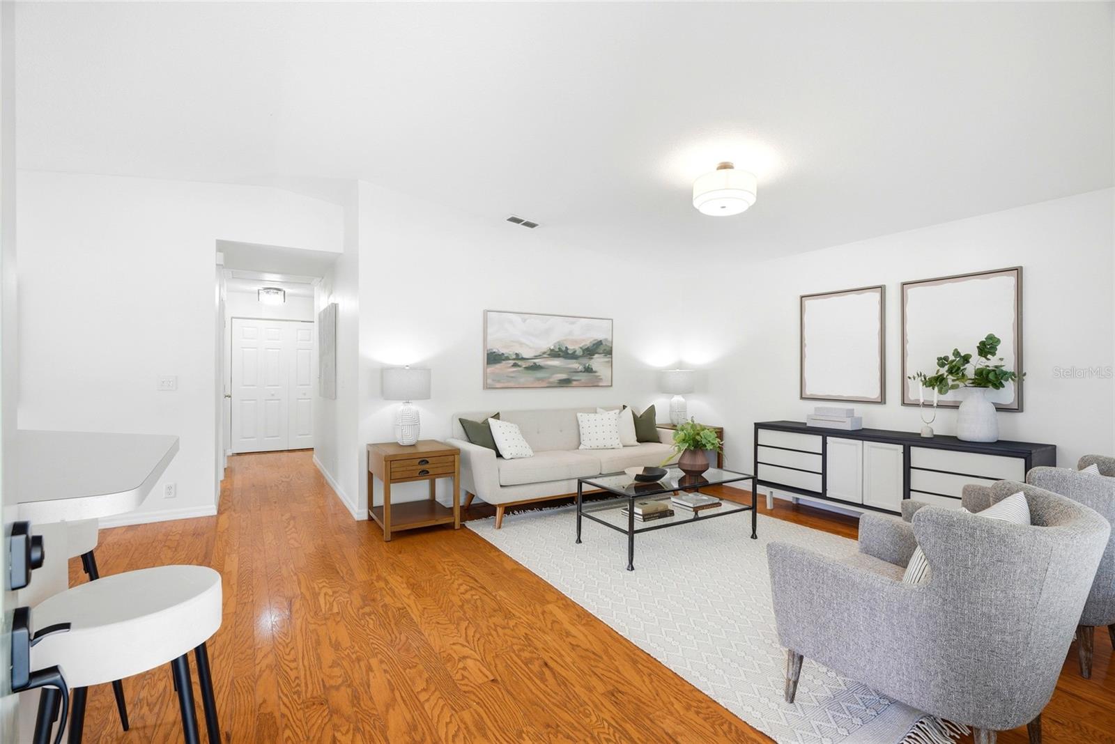 Beautiful hardwood floors flow throughout the open-concept living space.