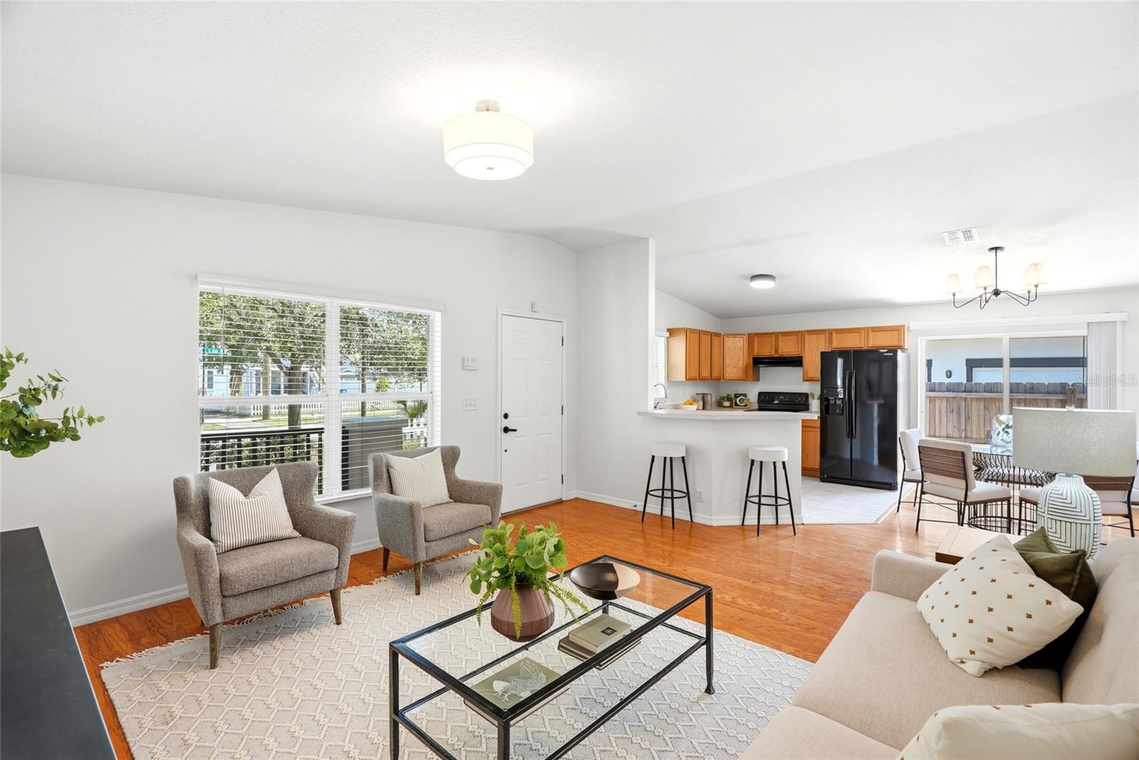 The living room, dining area, and kitchen connect seamlessly in a true open-concept design.