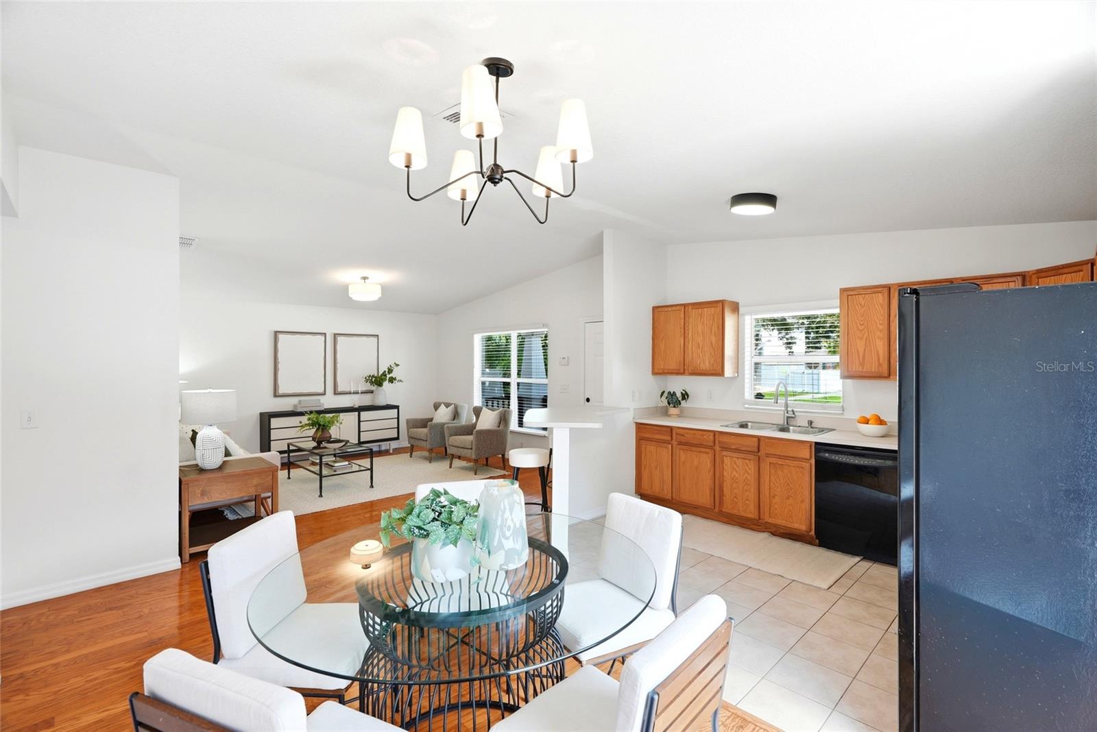 The kitchen opens directly to a bright dining area with sliding glass doors to the backyard.