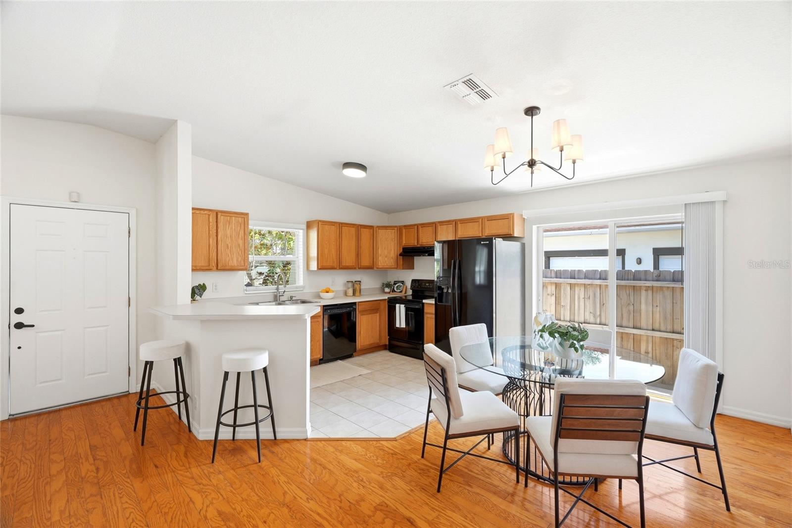 A breakfast bar connects the kitchen to the dining and living spaces, perfect for entertaining.