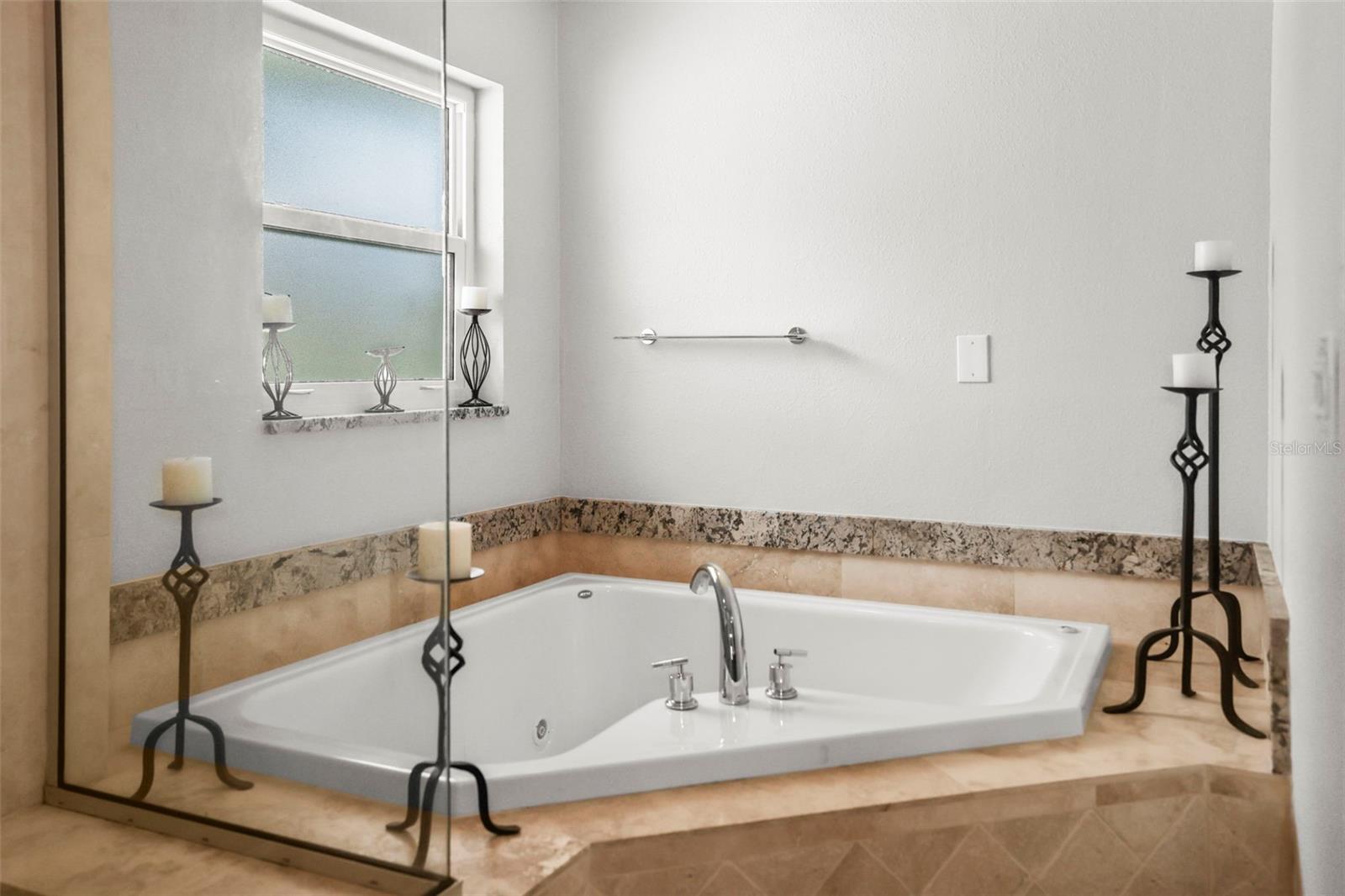 Primary bathroom large corner tub.