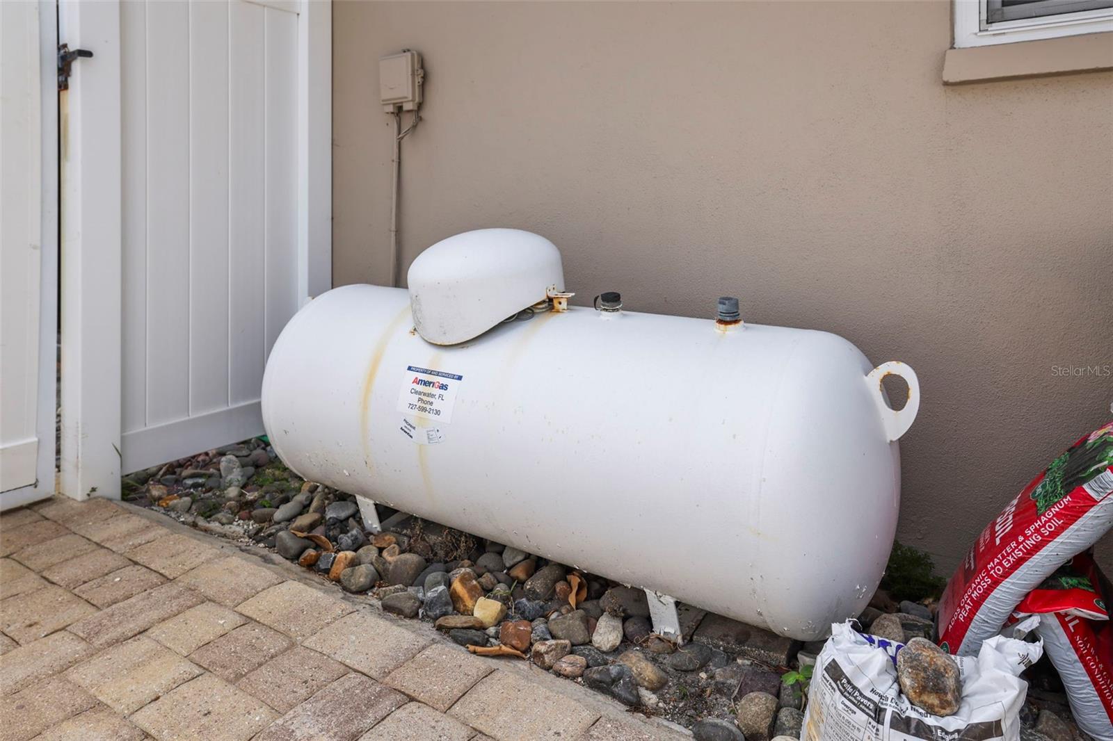 Propane tank for pool heater.