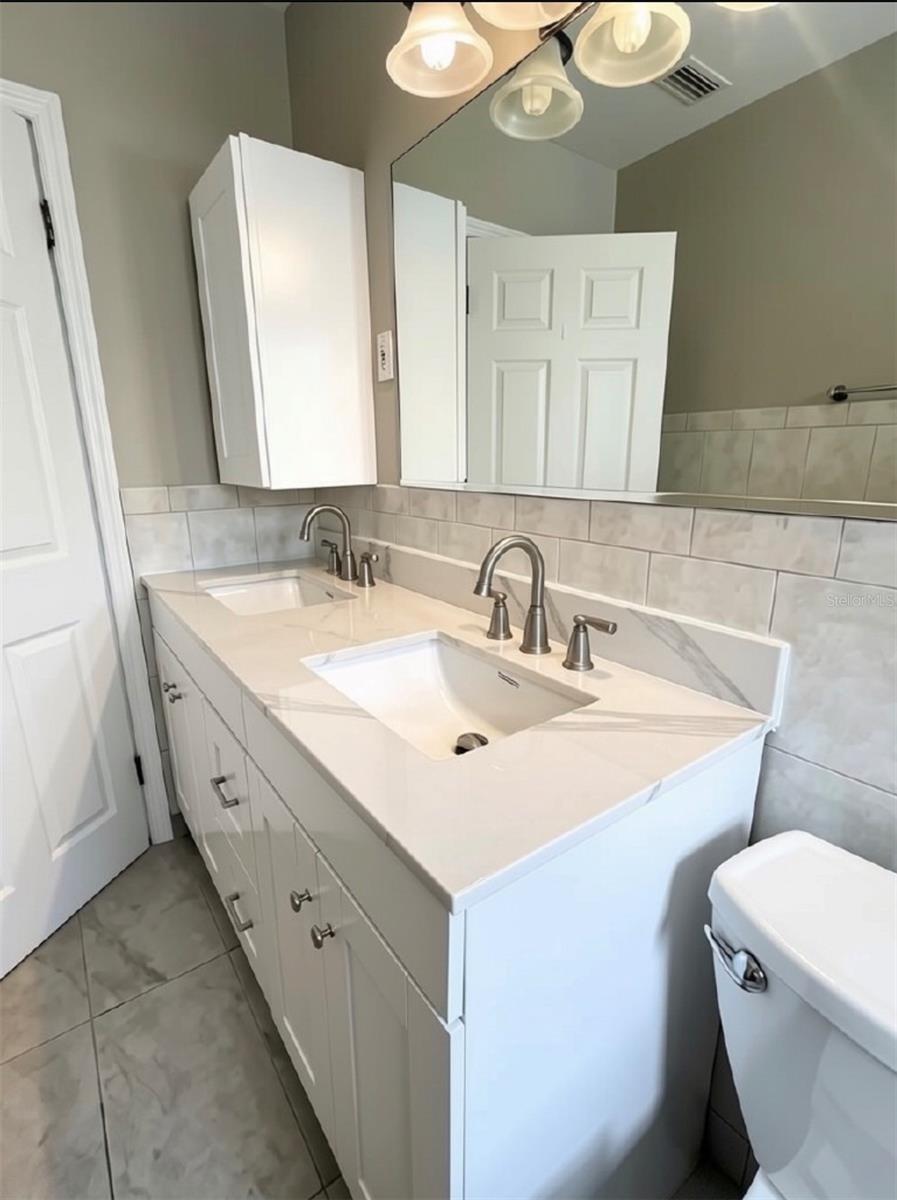 Second/guest bath- double sink & tub