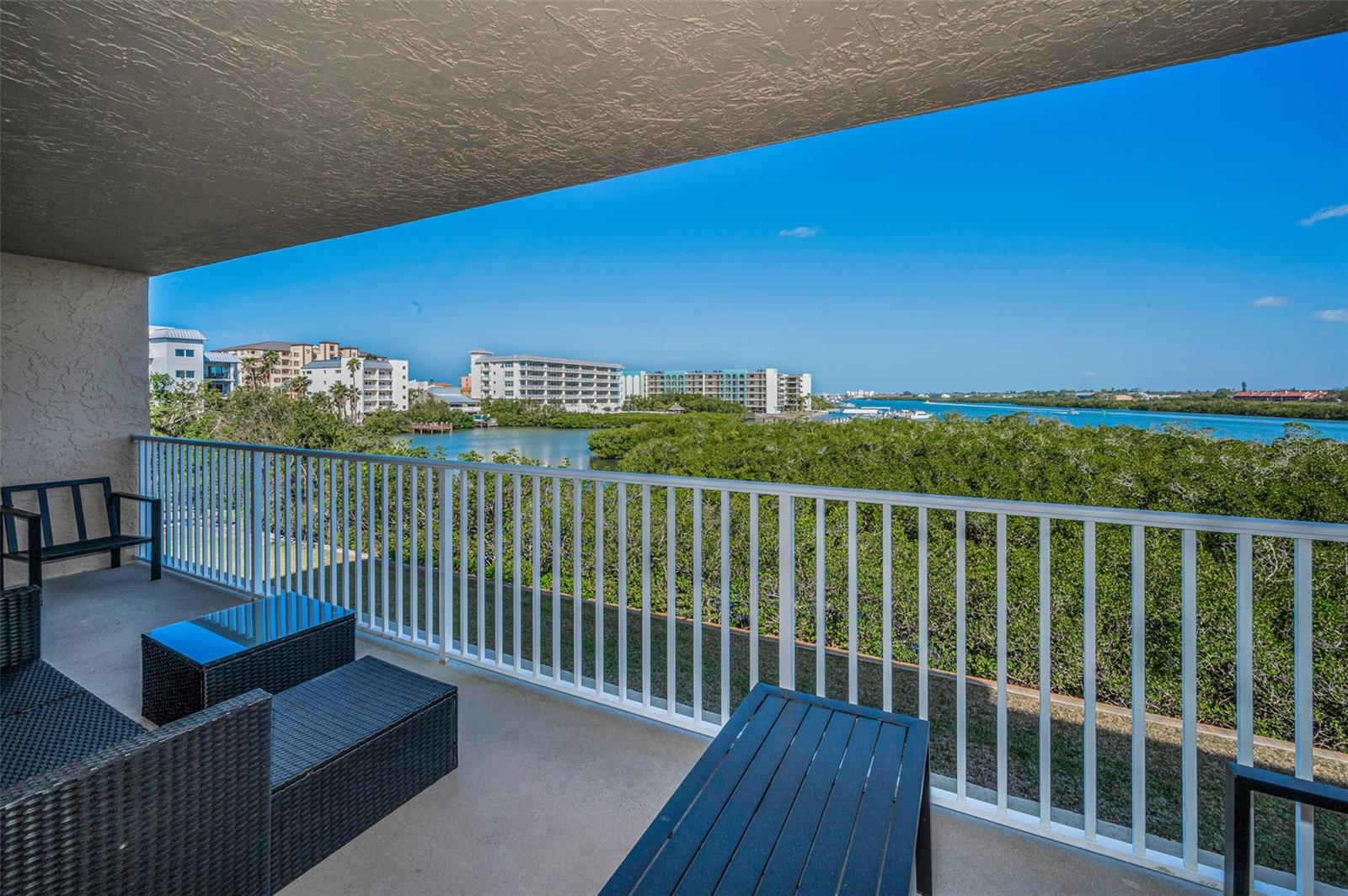 .. Large 24.7 X 6.3 Waterfront Balcony. Manatees & Young Dolphins are Always Playing Near Seawall. Balcony Shot Looking Left. The Water views are much much  better in person, This is a 3rd floor balcony, the greenery is only 5 feet above the ground but the cameras eye zeroes in on it.
