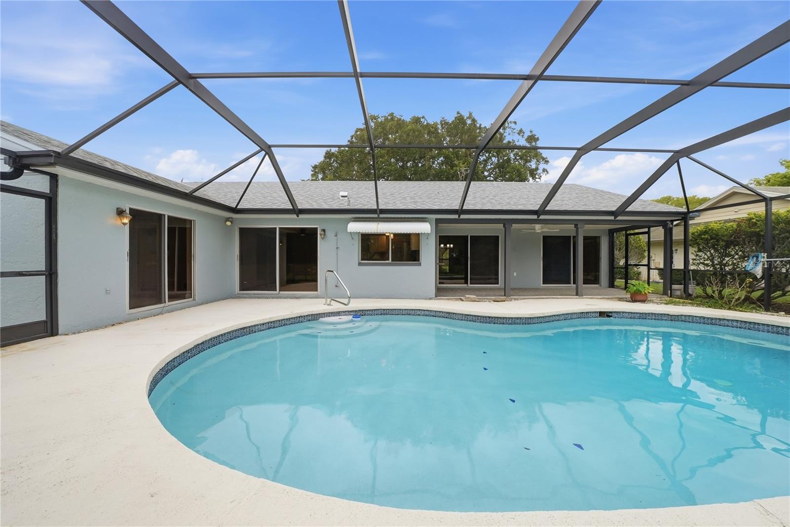 Private pool retreat surrounded by a full screened enclosure and ample space for lounging and entertaining.
