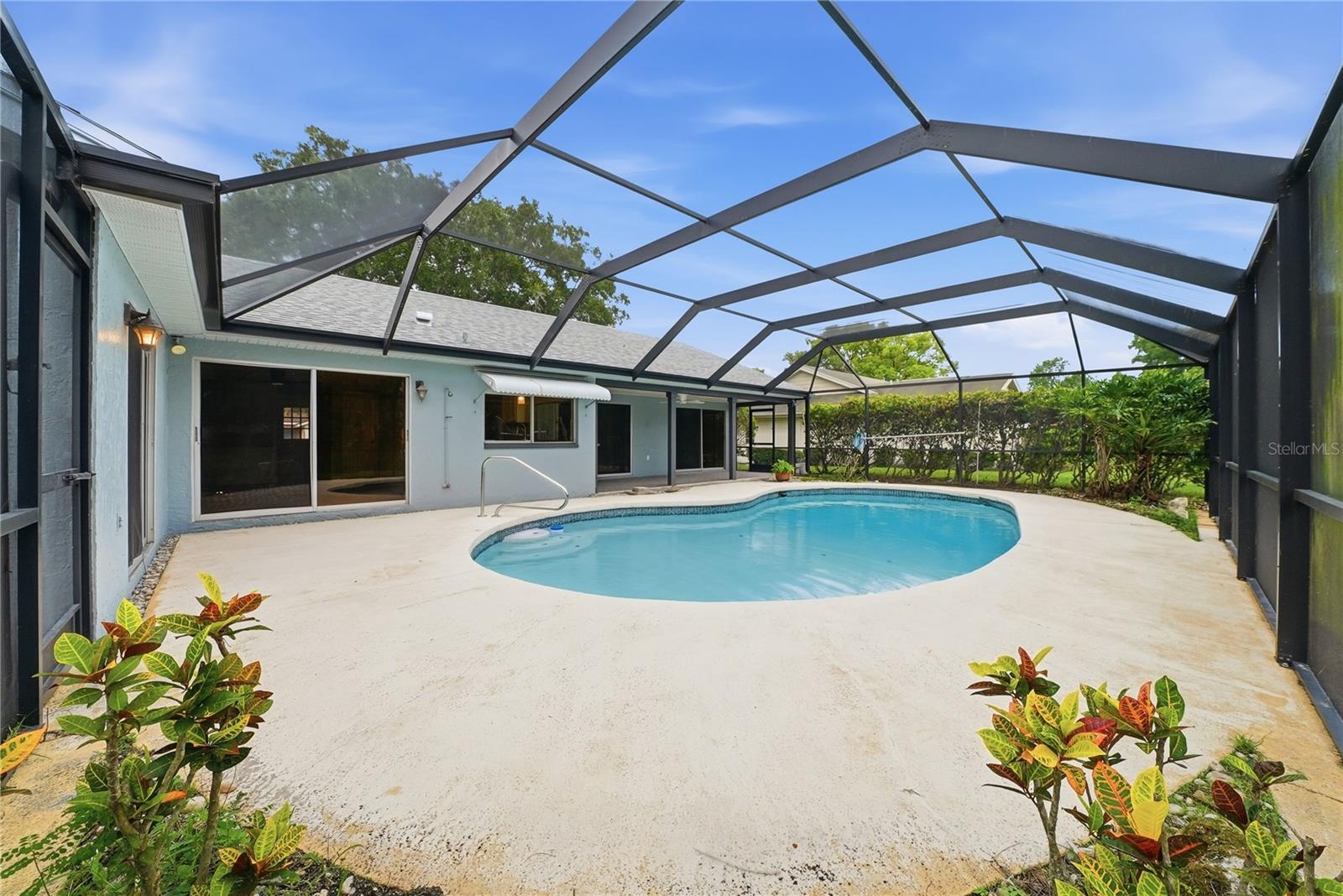 Expansive screened pool deck with room for outdoor dining, seating, and year-round Florida enjoyment.