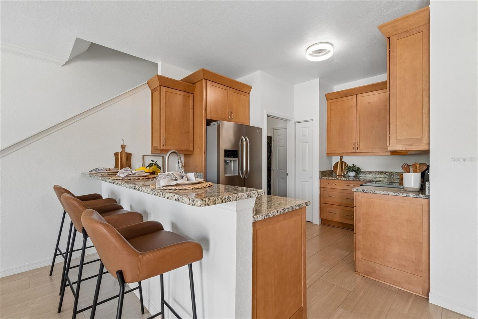 Beautiful kitchen with wood cabinets, granite countertops and stainless-steel appliances