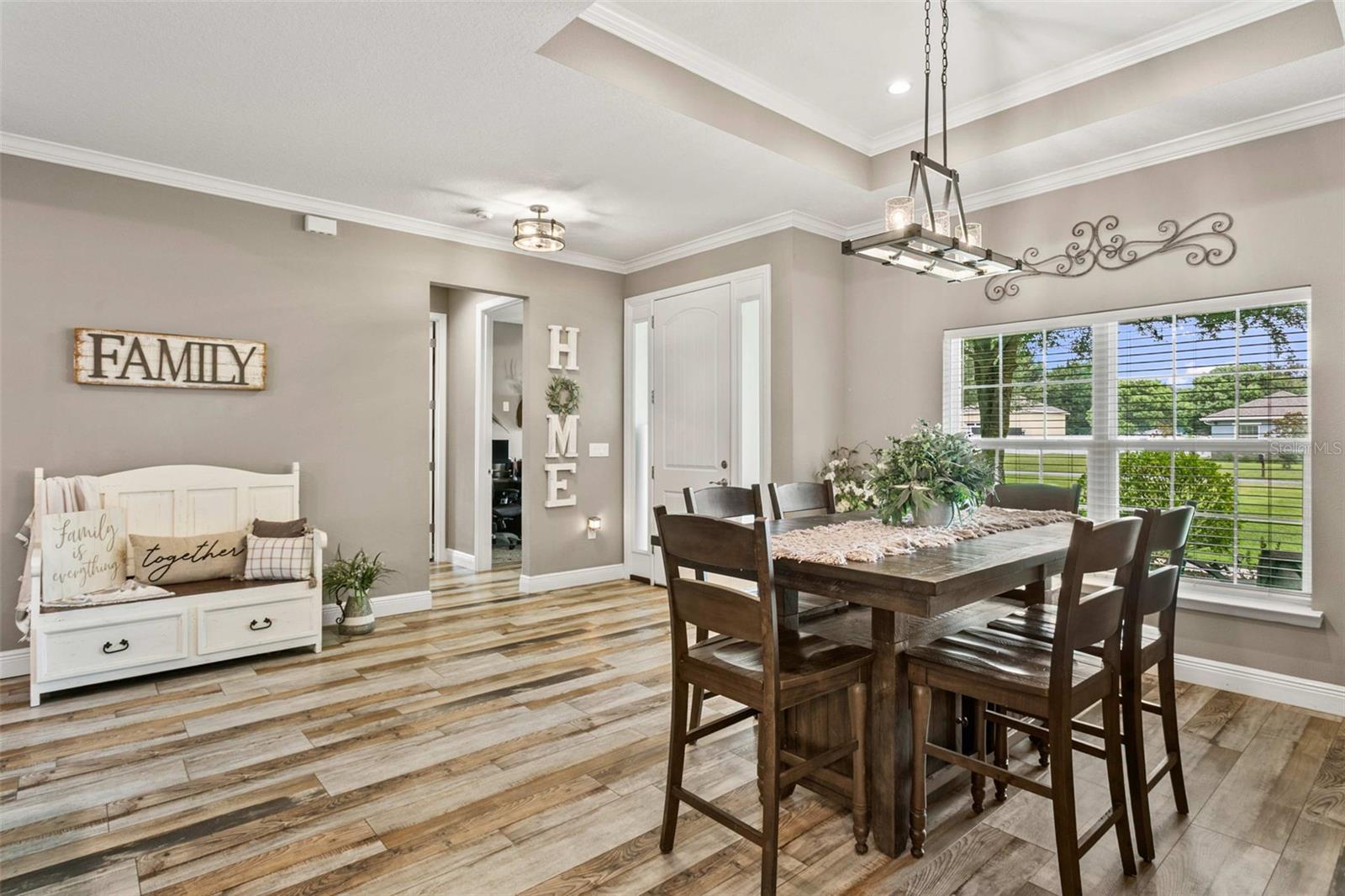 Elegant formal dining room with designer lighting, perfect for entertaining family and friends.