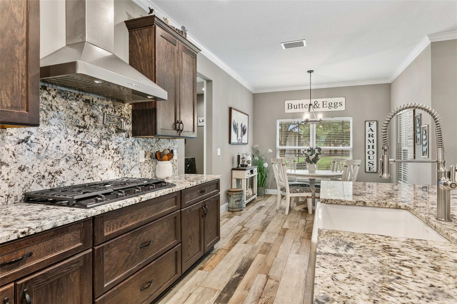 Chef's kitchen featuring custom cabinetry, granite countertops, premium appliances, and a large center island.