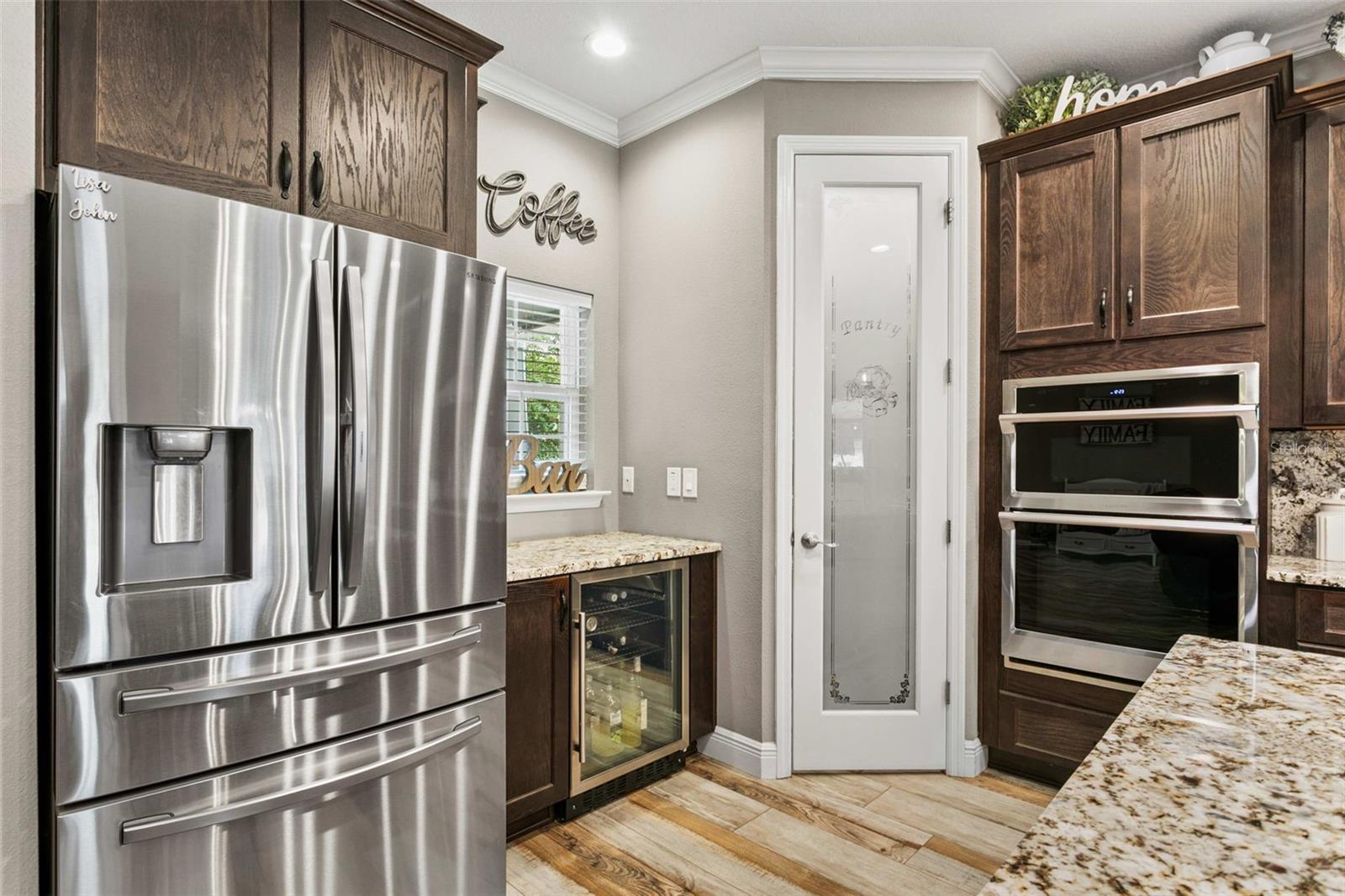 Chef's kitchen featuring custom cabinetry, granite countertops, premium appliances, and a large center island.