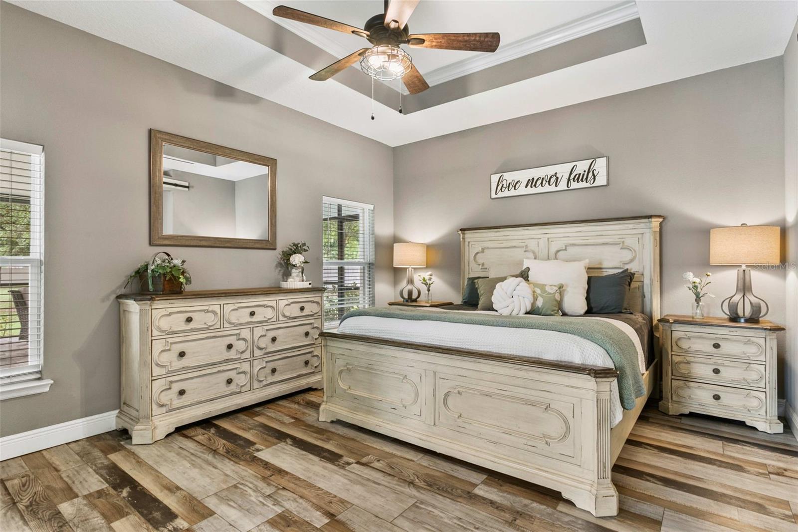 Luxurious primary suite featuring tray ceilings, abundant natural light, and a peaceful retreat.