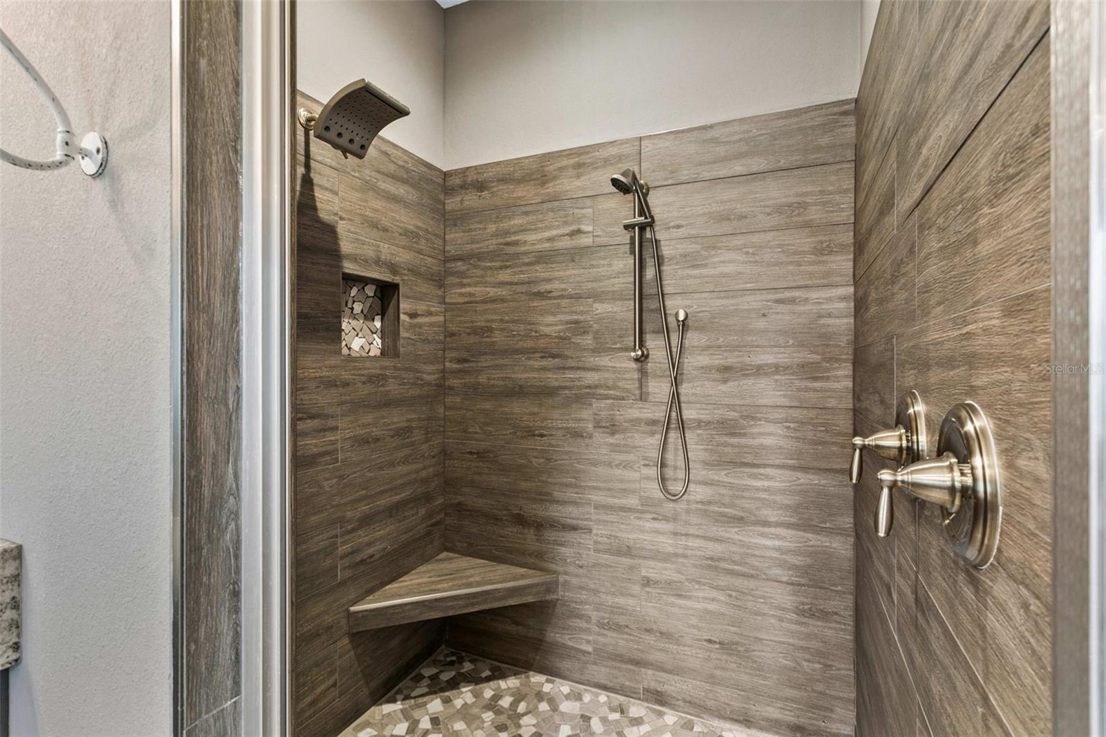 Spa-inspired primary bathroom featuring dual vanities, a soaking tub, oversized walk-in shower, and premium finishes.