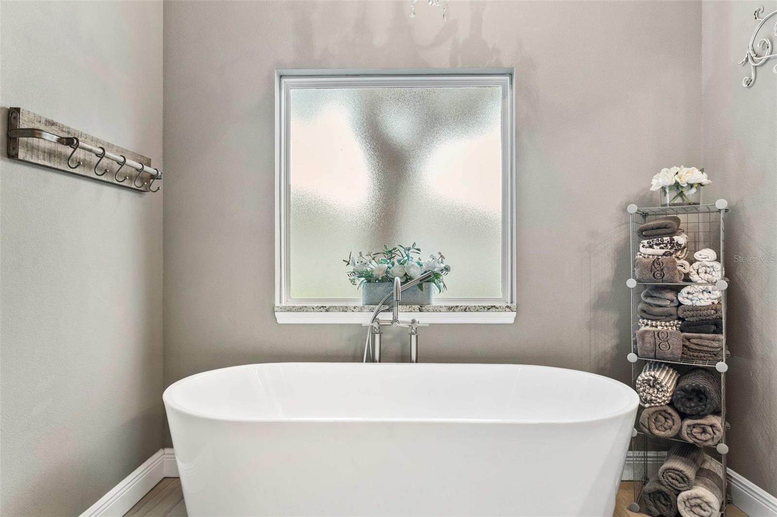 Spa-inspired primary bathroom featuring dual vanities, a soaking tub, oversized walk-in shower, and premium finishes.