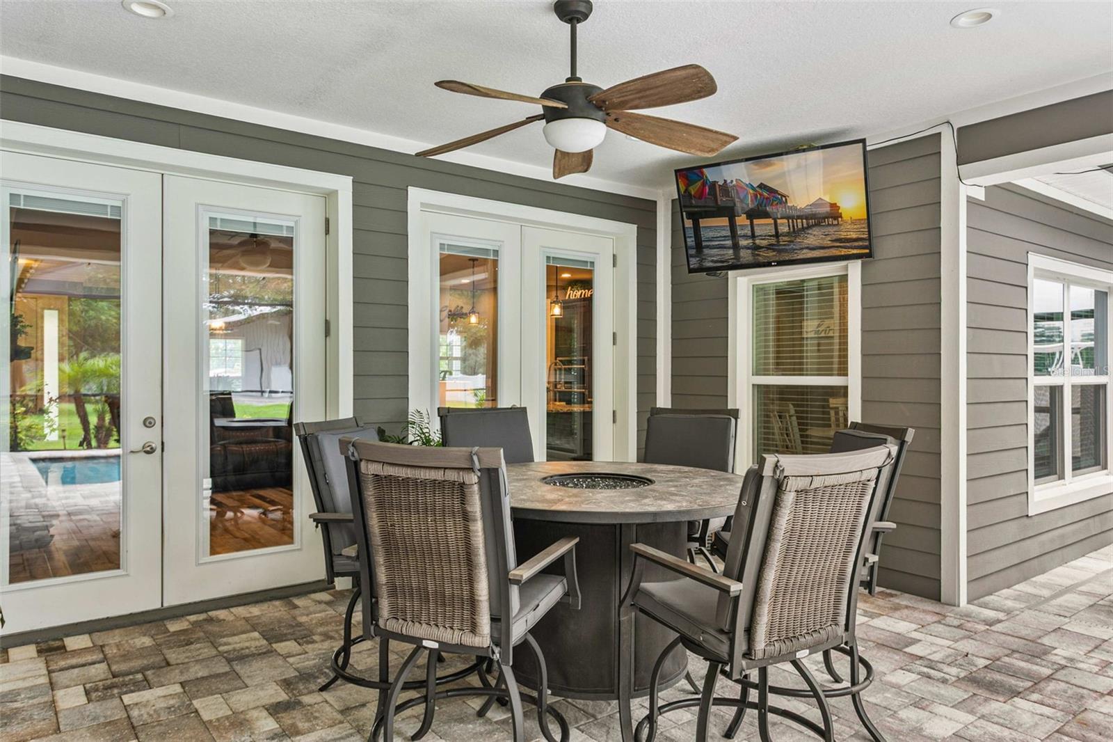 Covered outdoor living space overlooking the pool—perfect for entertaining.
