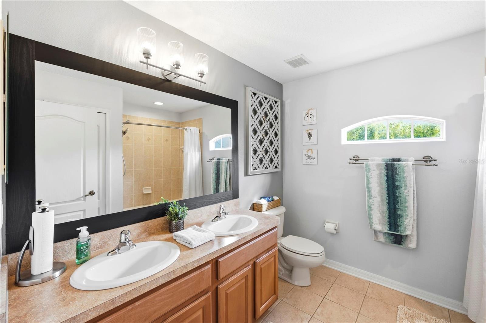 Spacious full bath with dual sinks.